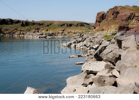 Desert lake with white and red rocks