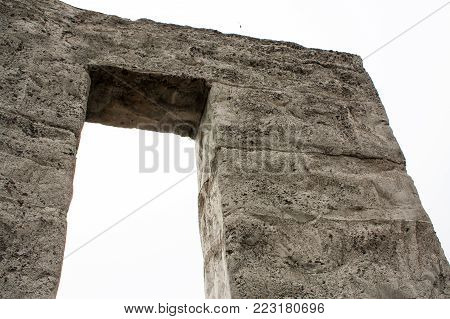 Concrete pillar arch with squared off edges and lines