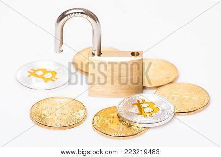 Many Silver And Golden Bitcoins With A Open Lock Isolated White Background