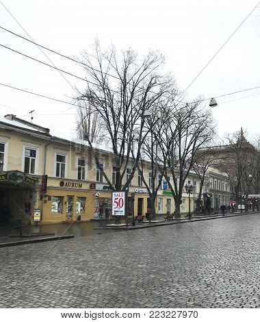 Odessa, Ukraine - December 28, 2017: People visit Deribasovskaya Street. Deribasovskaya is the central street of Odessa and one of the main attractions of the city.