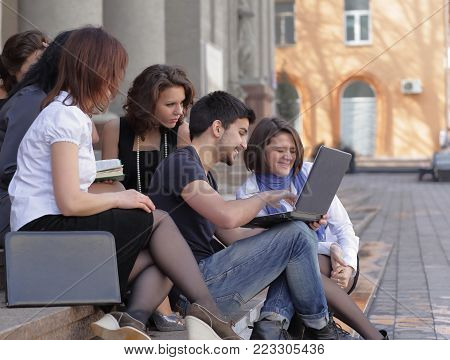 group of fellow students with books and laptop.education concept