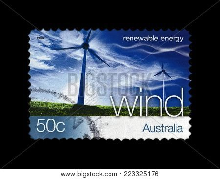 AUSTRALIA - CIRCA 2004: canceled stamp printed in Australia shows wind station on blue sky with clouds, wind renewable energy, circa 2004. vintage postal stamp isolated on black background.