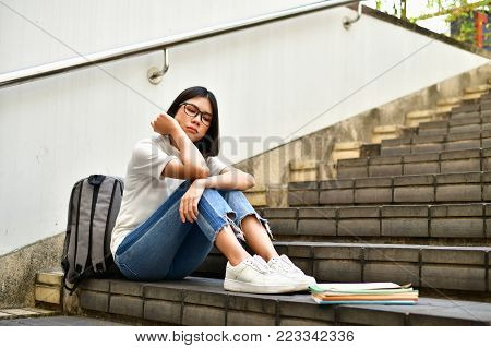 Education Concepts. Beautiful Asian girls are clear in their studies. The study of Asian women looks serious. Asian women Headache because of serious study. education of Asian women