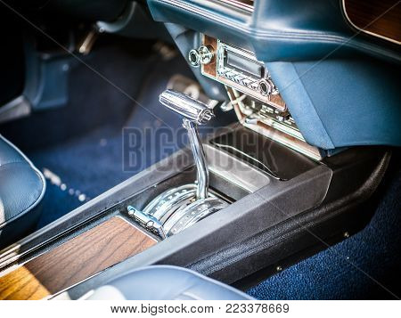 the classic car from the inside, you see the gear lever, the steering wheel and the ads