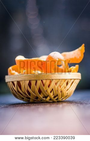 Fresh Peel Of Oranges,citrus Reticulata,citrus Aurantium In A Traditional Basket On Wooden Surface.