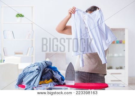 Inattentive husband burning clothing while ironing