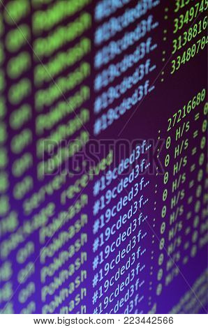 Macro snapshot of the program interface for crypto currency mining on the monitor of an office computer. The concept of mining bitcoins. The flow of information strings and data
