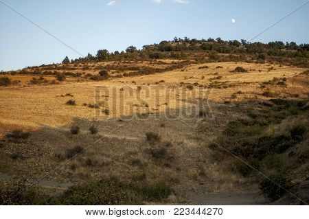 Mountain slope under blue sky, lighten by the sunset