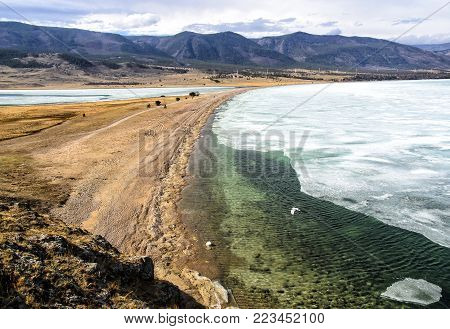 View above big beautiful lake Baikal with Ice floes floating on the water, Russia, Maloye sea