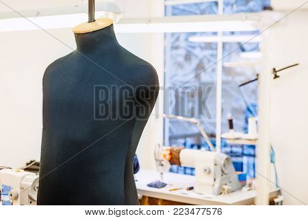 Close up male sew mannequin on talor working place. The concept of sewing production. Selective focus, space for text