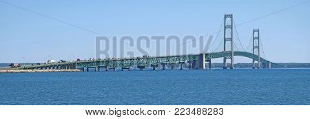 Spanning the Straits of Mackinac, which joins Lake Michigan and Lake Huron, the five-mile long Mackinac Bridge joins the upper peninsula of Michigan at St. Ignace to the lower peninsula of Michigan at Mackinaw City.  The bridge is sometimes called Mighty 