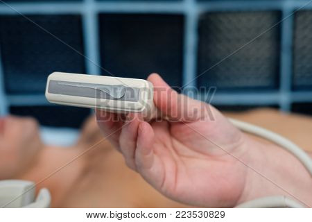 Ultrasonography Testing Concept. Medical Doctor With The Ultrasonography Device In A Hand