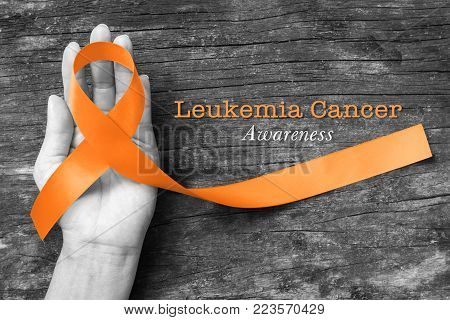 Leukemia Cancer Awareness Orange Ribbon Color On Wood Background (clipping Path);