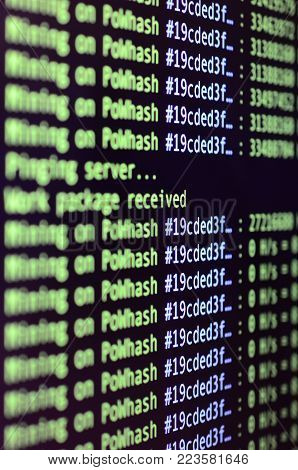Macro snapshot of the program interface for crypto currency mining on the monitor of an office computer. The concept of mining bitcoins. The flow of information strings and data