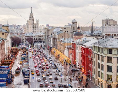MOSCOW, RUSSIA - January 07, 2018. Cars moving on Novaya ploschad street decorated for New Year celebration. View on Kotelnicheskaya Embankment Building, one of seven Stalinist skyscrapers.