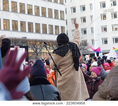 STOCKHOLM, SWEDEN - JAN 21, 2018: Women raising their hands in the Womens March, a worldwide protest for women's rights in central Stockholm, Norrmalmstorg, Sweden, January 21, 2018