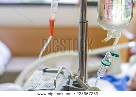 Saline bag and drip set for intravenous infusion for patient in modern hospital, selective focus on drip set