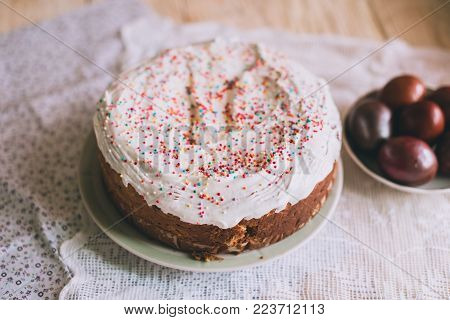 Easter Table With Traditional Easter Cakes And Easter Eggs With Blossoming Tree Branch