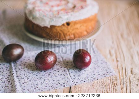 Easter Table With Traditional Easter Cakes And Easter Eggs With Blossoming Tree Branch