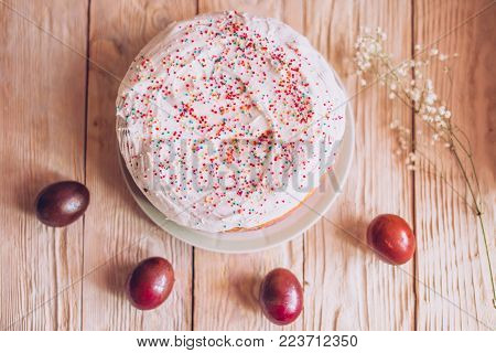 Easter Table With Traditional Easter Cakes And Easter Eggs With Blossoming Tree Branch