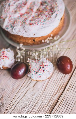 Easter Table With Traditional Easter Cakes And Easter Eggs With Blossoming Tree Branch