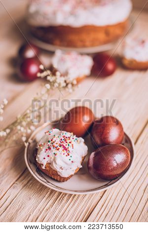 Easter Table With Traditional Easter Cakes And Easter Eggs With Blossoming Tree Branch