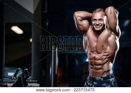 Brutal Strong Bodybuilder Athletic Men Pumping Up Muscles With Dumbbells.