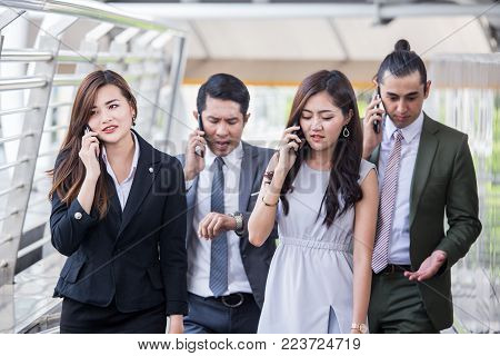 Businesspeople Using Smartphone For Talk Business Project While Walking. Businesspeople  Working Con