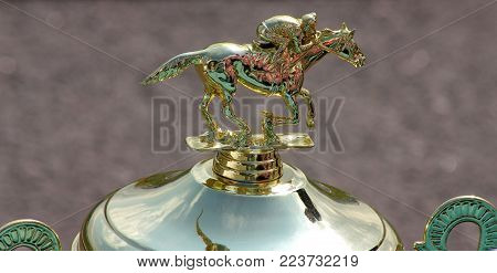 Pyatigorsk, Russia - Jule 08,2011:Classic Gold Cup with the image of a jockey on a horse, a pedestal with the engraved inscription 