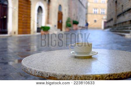Cup of coffee on the street cafe table