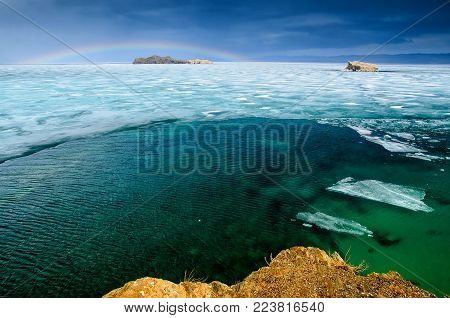View above big beautiful lake Baikal with Ice floes floating on the water, Russia, Maloye sea