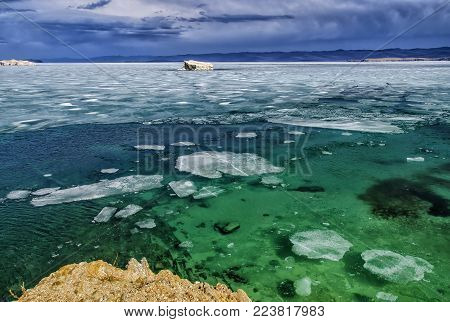 View above big beautiful lake Baikal with Ice floes floating on the water, Russia, Maloye sea