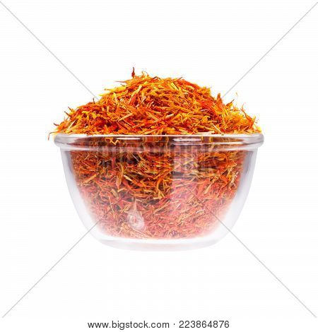 Safron stamens in saucepan on white background. High resolution photo.