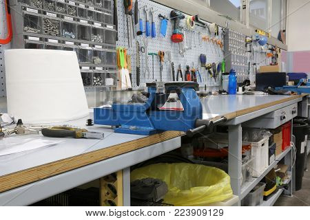 workbench in a mechanical workshop for repairs with blue heavy vice