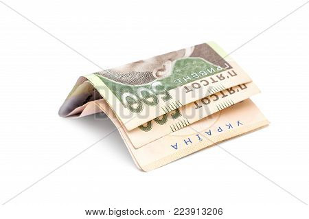 Folded five hundred hryvnia bills on white background.