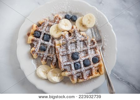 home made sweet waffles with blueberries for breakfast
