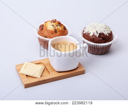 Classic espresso in white cup with homemade cake and chocolate on white background