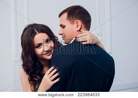Family studio photography. Wedding photography pair. Husband and wife. Strong black hair and a beautiful blonde.