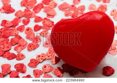 big and small red hearts on a white background from fabric