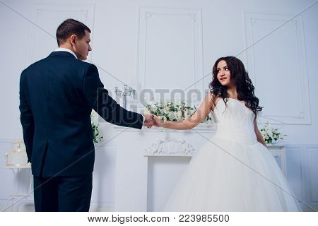 Family studio photography. Wedding photography pair. Husband and wife. Strong black hair and a beautiful blonde.