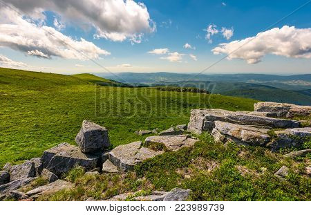 grassy slope on fine summer day. beautiful landscape with peak in the distance. lovely nature scenery under the cloudy sky