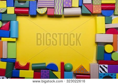 Colorful Kids Toys Frame On Wooden Background. Top View. Flat Lay. Copy Space For Text.