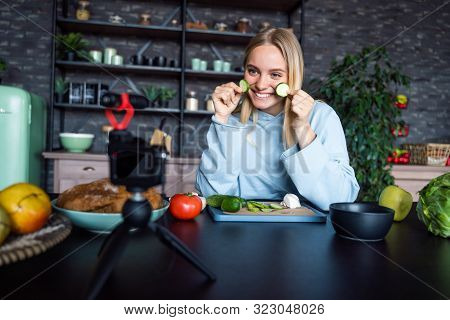 Young Beautiful Blonde Takes On Videos As She Cooks In The Kitchen