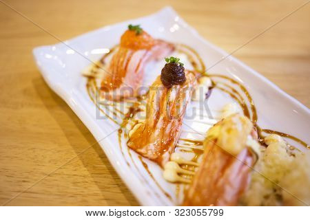 Salmon Sushi Set Such As Salmon Mentaiko, Miso, Cheese And Crunch Topping In White Plate At Japanese