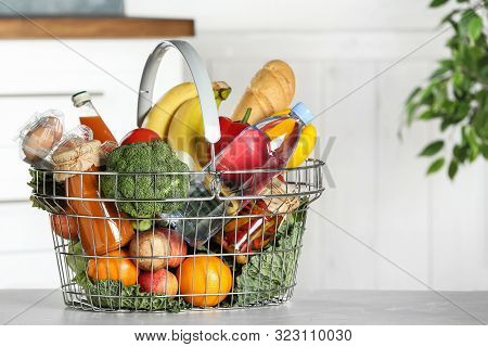 Shopping Basket With Grocery Products On Grey Table Indoors. Space For Text