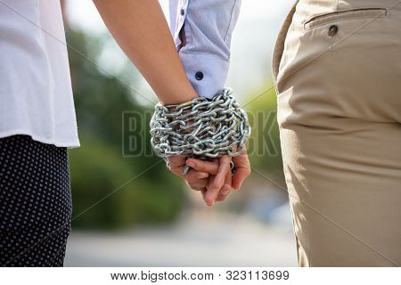Couple's Hand Tied With Metal Chain