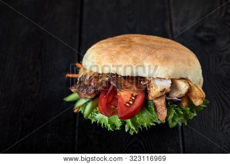 Close Up Of Kebab Sandwich On Wooden Background