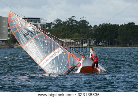 Lake Macquarie, Australia - April 16, 2013: Capsized Competitors Attempting To Upright An Overturned