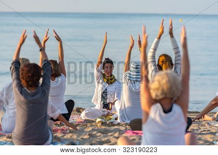 Altafulla, Tarragona, Spain : 219 August 31 :  Yoga Instructor Leading A Group Session At Sunset On 