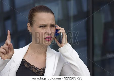 Angry Displeased Young Businesswoman Talking On Cell Phone, Calling Customer Support. Unpleasant Con